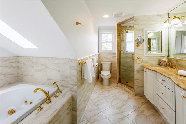 full bathroom featuring a skylight, visible vents, ornamental molding, a shower stall, and tile walls