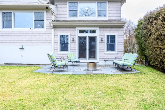 rear view of house featuring a patio area and a yard