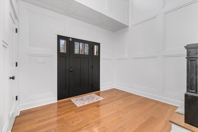 entrance foyer featuring light wood-type flooring and a decorative wall