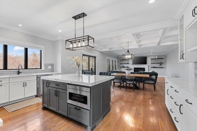 kitchen featuring dishwasher, gray cabinets, light wood-style floors, white cabinetry, and a sink