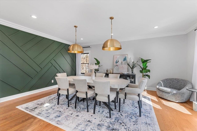 dining space with ornamental molding, recessed lighting, and light wood-style floors