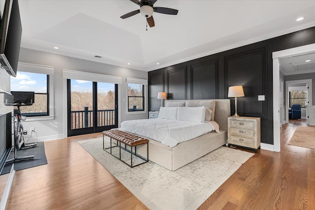 bedroom featuring access to exterior, crown molding, recessed lighting, wood finished floors, and baseboards