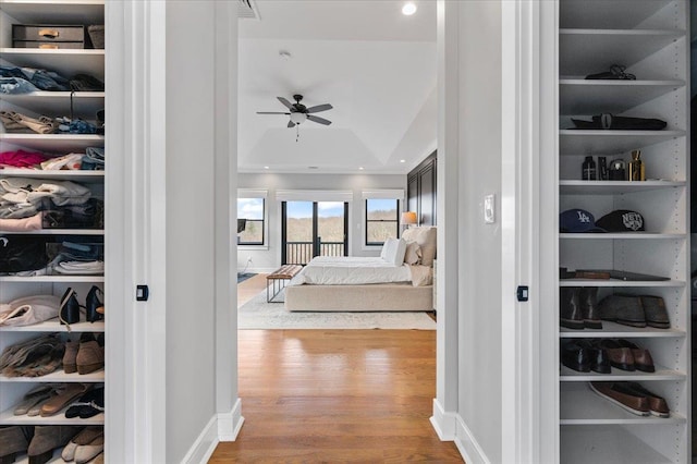 bedroom with a closet, baseboards, and wood finished floors