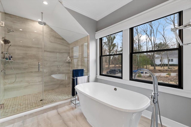 full bath with a freestanding tub, a shower stall, baseboards, and crown molding