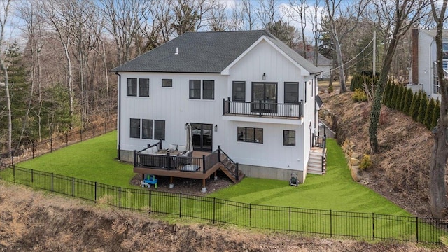 back of property with roof with shingles, a yard, stairway, a fenced backyard, and a wooden deck