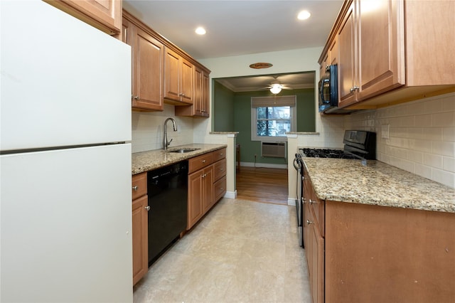 kitchen with a sink, baseboards, ornamental molding, a wall mounted AC, and black appliances