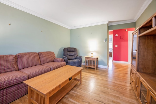 living area with light wood finished floors, baseboards, and ornamental molding