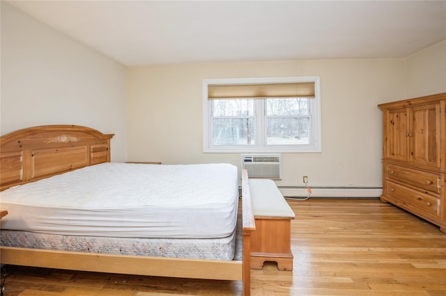 bedroom featuring a baseboard radiator, a wall mounted air conditioner, and light wood finished floors