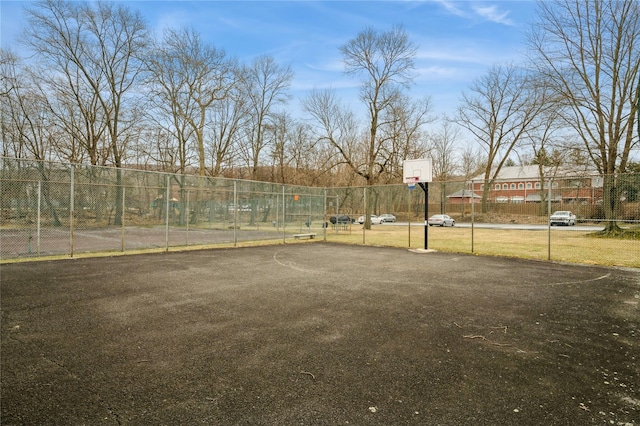 view of yard featuring community basketball court and fence