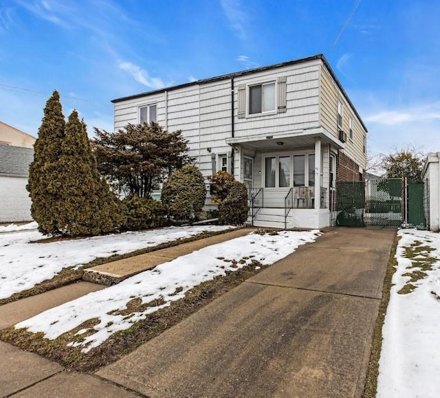 view of front of home with a gate and a porch