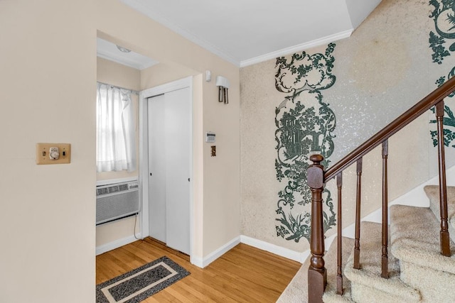 entrance foyer featuring baseboards, visible vents, stairway, wood finished floors, and crown molding