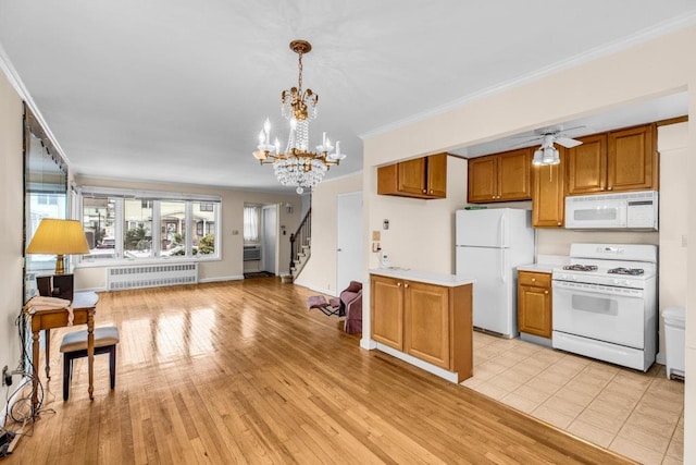 kitchen featuring white appliances, radiator heating unit, brown cabinets, light countertops, and crown molding