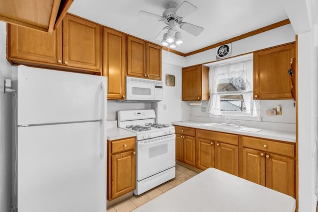 kitchen featuring ceiling fan, white appliances, a sink, light countertops, and brown cabinetry