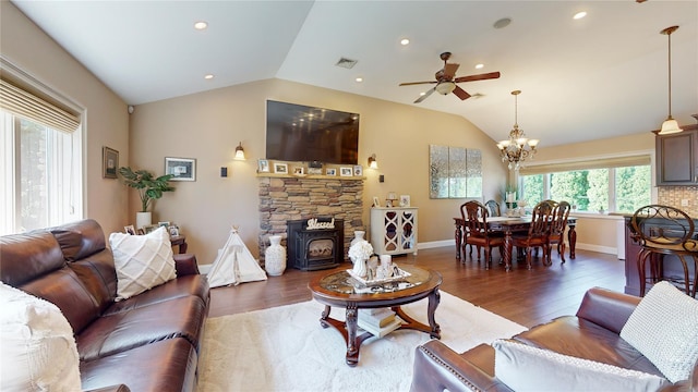 living room featuring visible vents, vaulted ceiling, baseboards, and wood finished floors