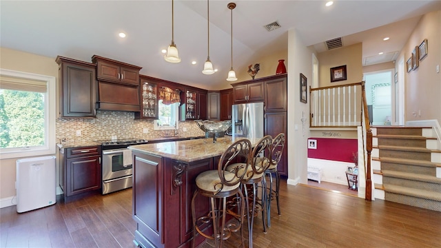 kitchen featuring a healthy amount of sunlight, visible vents, appliances with stainless steel finishes, and light stone counters