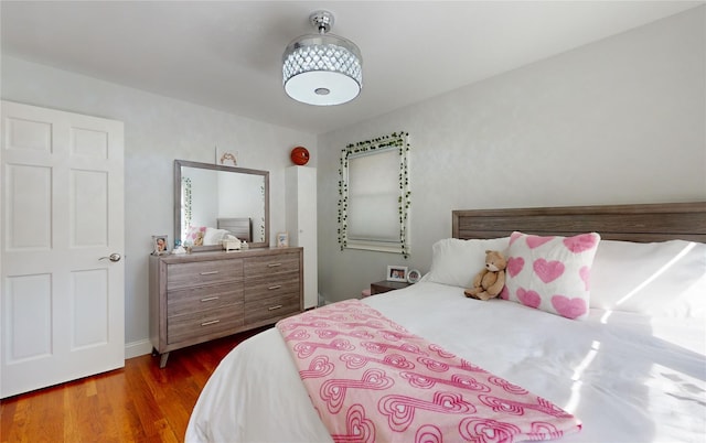 bedroom featuring dark wood finished floors