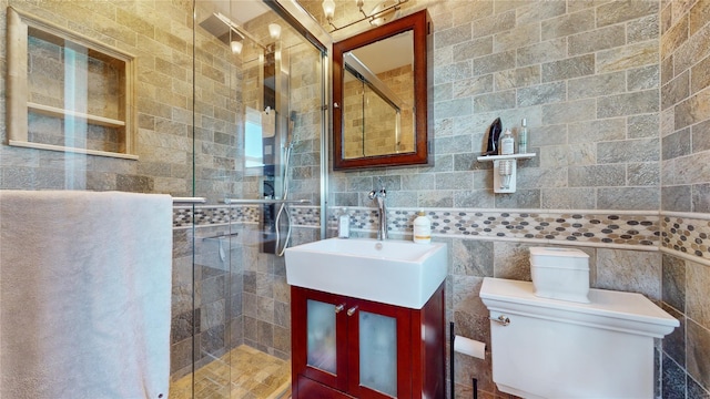 full bathroom with toilet, a stall shower, tile walls, and vanity