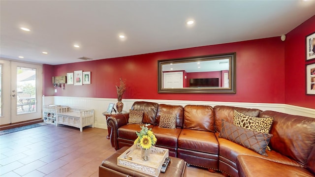 living room with french doors, a wainscoted wall, recessed lighting, visible vents, and wood finished floors