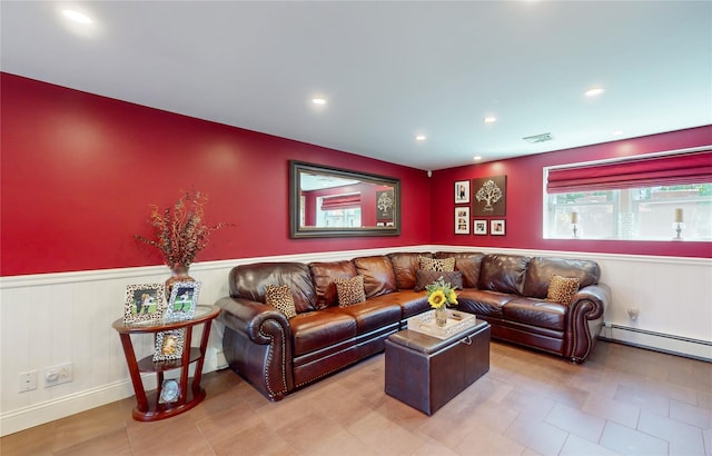 living area with wainscoting, a baseboard radiator, visible vents, and recessed lighting