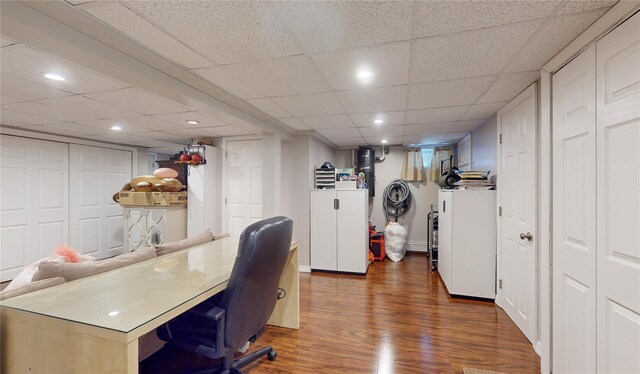 office space featuring dark wood-style floors, recessed lighting, and a drop ceiling