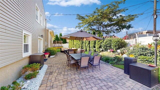 view of patio / terrace featuring outdoor dining space and fence