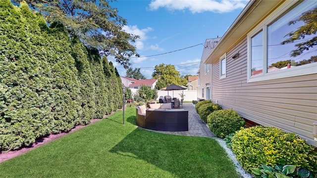 view of yard with a patio area, outdoor lounge area, and fence