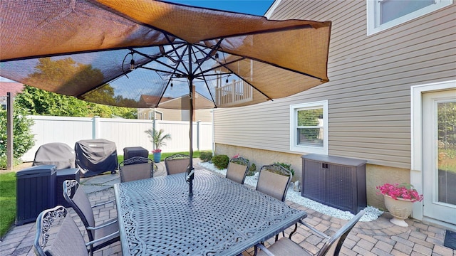 view of patio / terrace with outdoor dining space, area for grilling, and fence