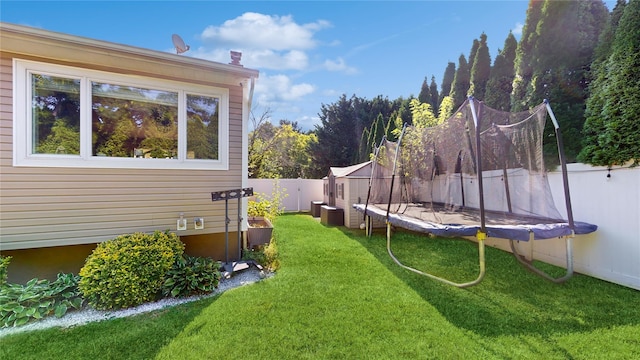 view of yard featuring a trampoline and a fenced backyard