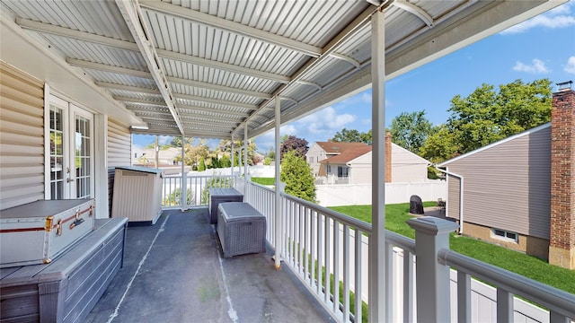 view of patio / terrace featuring a balcony, a residential view, and french doors