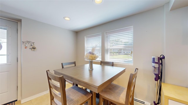 dining room with light tile patterned floors, a baseboard radiator, a wealth of natural light, and recessed lighting