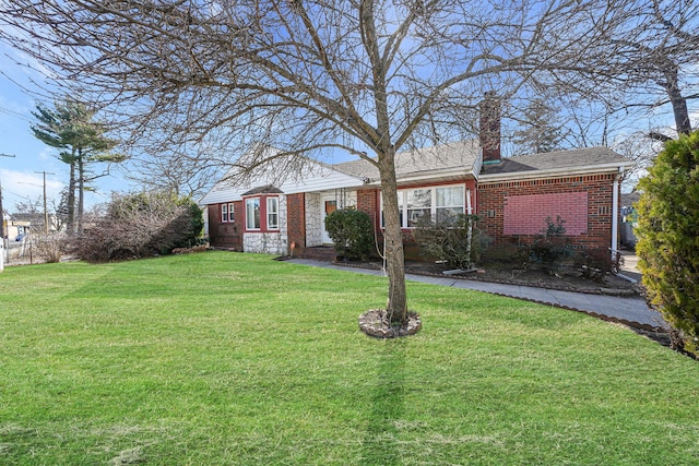 ranch-style home with a front yard, a chimney, and brick siding