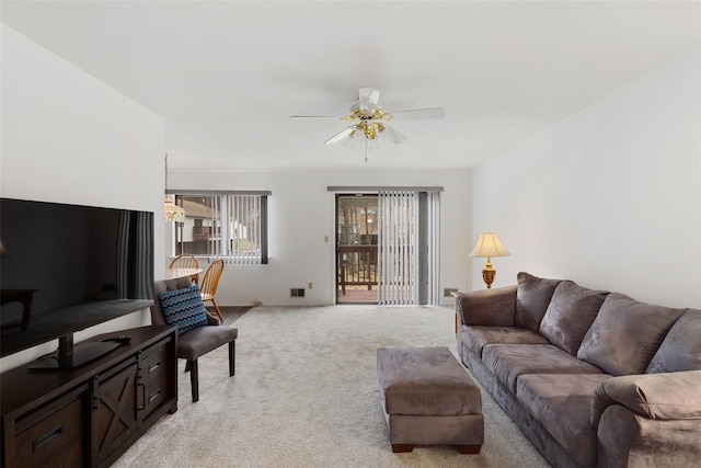 living room featuring light carpet, ceiling fan, and visible vents