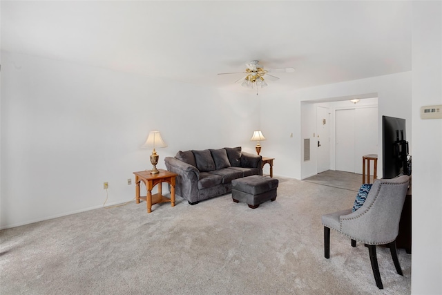 carpeted living room with ceiling fan and visible vents