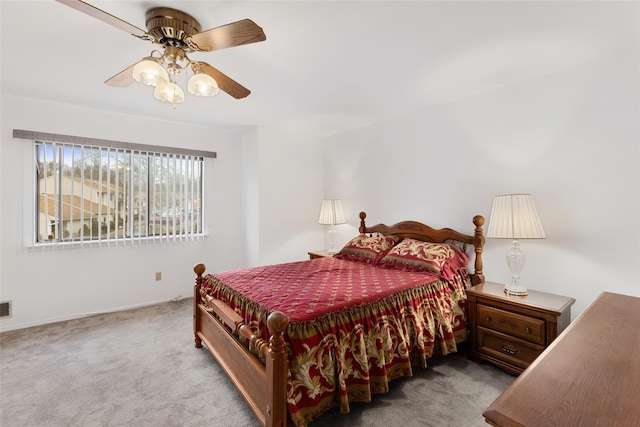 carpeted bedroom with ceiling fan and visible vents