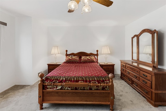 bedroom with a ceiling fan and light colored carpet