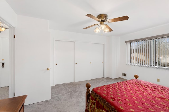 bedroom featuring carpet, visible vents, ceiling fan, and a closet