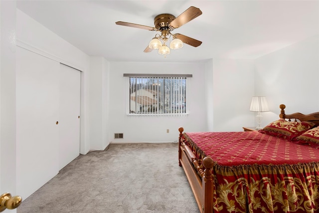 carpeted bedroom with ceiling fan and visible vents