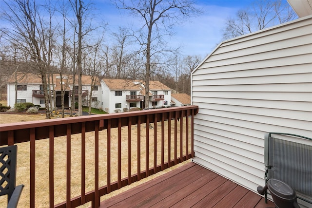 wooden terrace featuring central air condition unit and a residential view