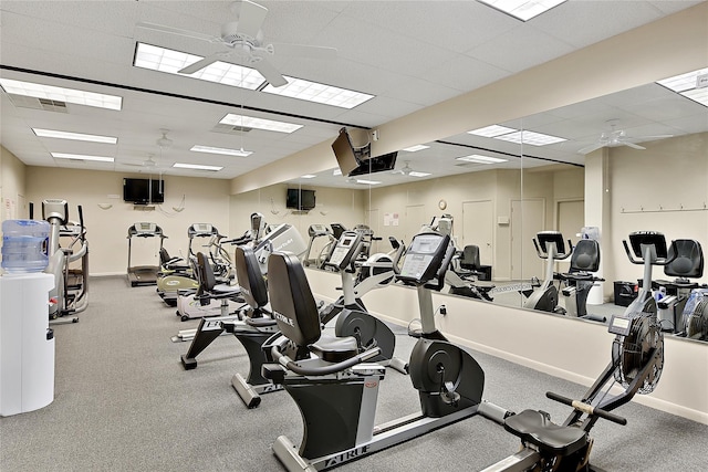 gym featuring baseboards, visible vents, a drop ceiling, and a ceiling fan