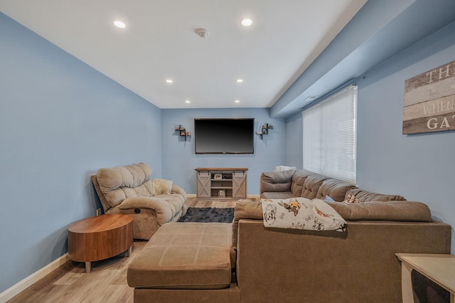 living room featuring light wood-type flooring, baseboards, and recessed lighting