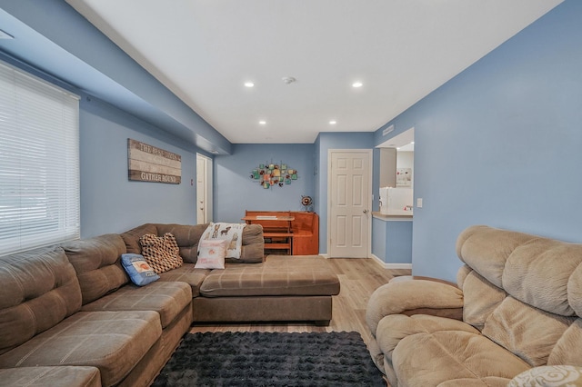 living room with recessed lighting, baseboards, and light wood finished floors