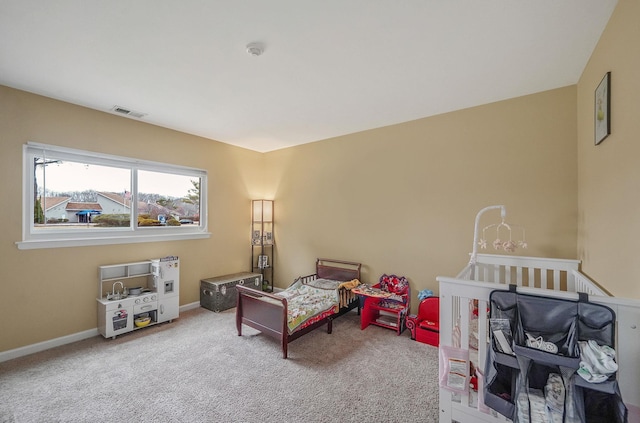 carpeted bedroom featuring visible vents and baseboards