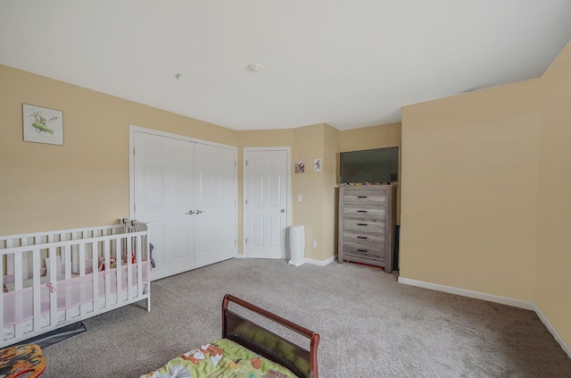 bedroom with carpet, baseboards, and a closet