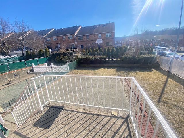wooden terrace featuring a residential view and fence