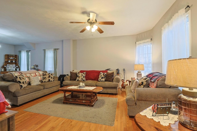 living area with ceiling fan and wood finished floors