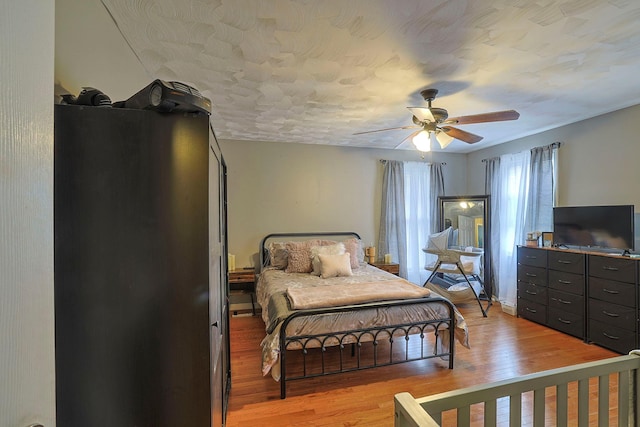 bedroom with light wood-type flooring and ceiling fan