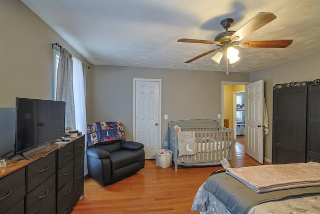 bedroom with a ceiling fan and light wood-style flooring