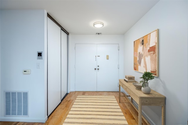 doorway to outside featuring light wood-style floors and visible vents