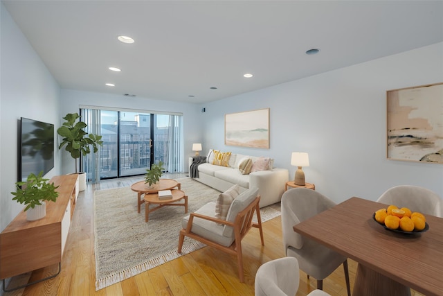 living area featuring light wood-style flooring, visible vents, and recessed lighting