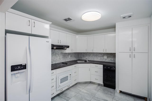 kitchen with visible vents, dark countertops, under cabinet range hood, black appliances, and a sink